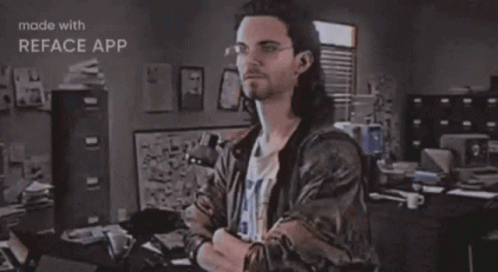 A Man Is Standing In Front Of A Sign That Says Hackerman GIF