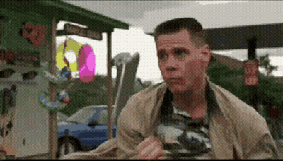 A Man Is Standing In Front Of A Sign That Says L32 On It GIF