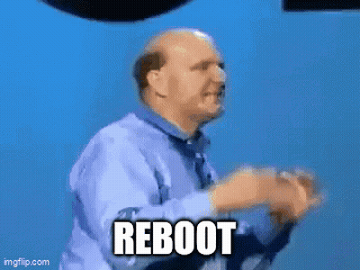 A Man Is Standing In Front Of A Sign That Says Microsoft Windows Reboot GIF