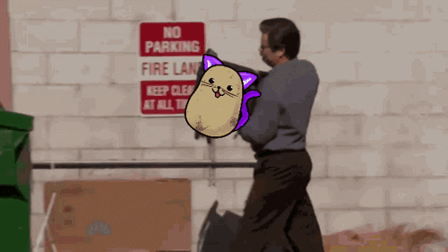 A Man Is Standing In Front Of A Sign That Says No Parking Fire Lane GIF
