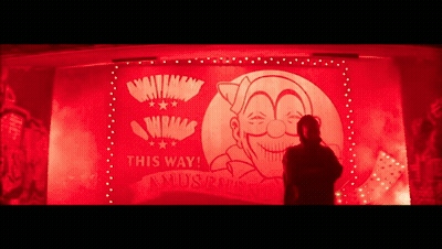 A Man Is Standing In Front Of A Sign That Says This Way ! GIF