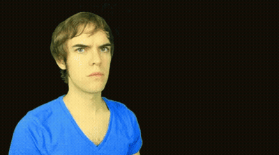A Man Is Standing In Front Of A Sign That Says Way Too Soon GIF