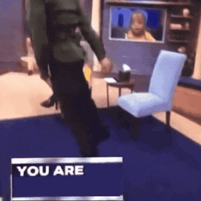 A Man Is Standing In Front Of A Sign That Says " You Are " GIF