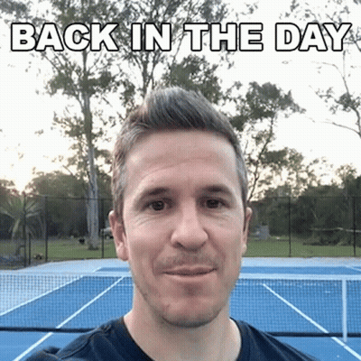 A Man Is Standing In Front Of A Tennis Court With The Words Back In The Day Written Above Him GIF
