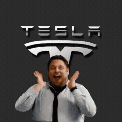 A Man Is Standing In Front Of A Tesla Sign GIF