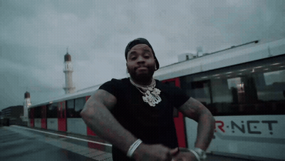 A Man Is Standing In Front Of A Train That Says R-Net On The Side GIF