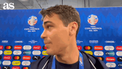 A Man Is Standing In Front Of A Wall That Says Copa America Usa 2024 GIF