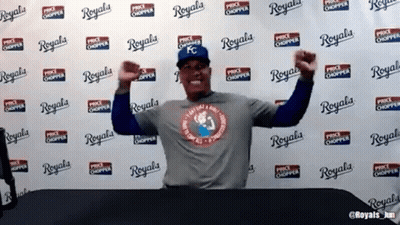 A Man Is Standing In Front Of A Wall That Says Royals GIF