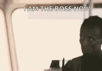 A Man Is Standing In Front Of A Window And Says `` I Am The Boss Now Look At Me '' . GIF