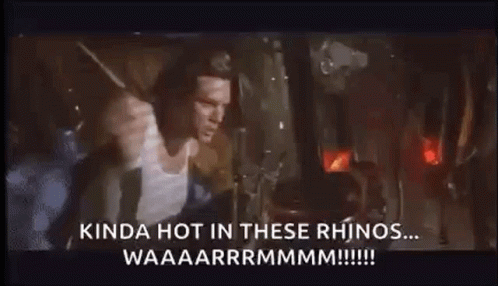 A Man Is Standing In Front Of A Window With A Rhino Coming Out Of It And Screaming . GIF