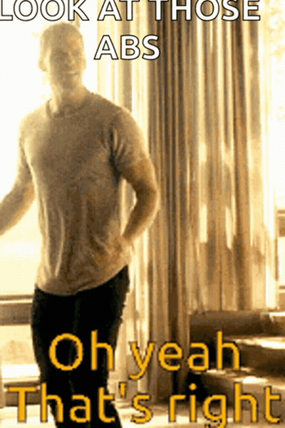 A Man Is Standing In Front Of A Window With The Caption " Look At Those Abs " GIF