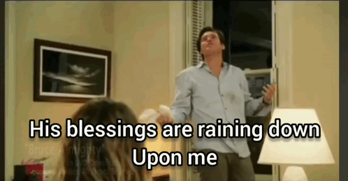 A Man Is Standing In Front Of A Window With The Words " His Blessings Are Raining Down Upon Me " GIF