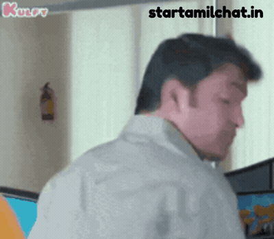 A Man Is Standing In Front Of A Window With The Words Starttamilchat.in Written On The Bottom GIF