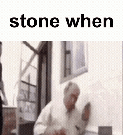 A Man Is Standing In Front Of A Window With The Words `` Stone When '' On The Bottom . GIF