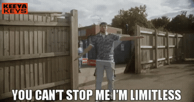 A Man Is Standing In Front Of A Wooden Fence With The Words " You Can 'T Stop Me I 'M Limitless " GIF