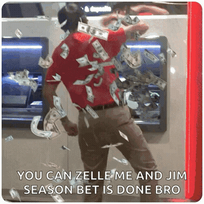 A Man Is Standing In Front Of An Atm Machine With Money Falling From It GIF