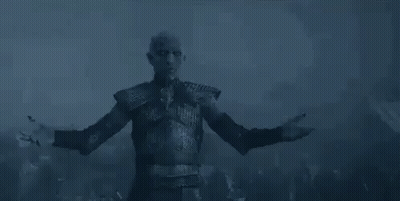 A Man Is Standing In The Dark With His Arms Outstretched . GIF
