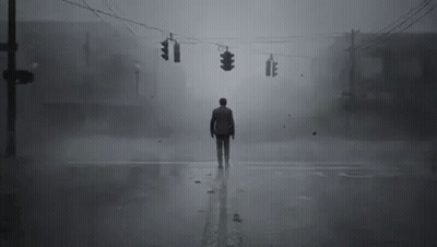 A Man Is Standing In The Middle Of A Foggy Street At An Intersection . GIF