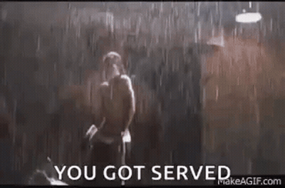 A Man Is Standing In The Rain With The Words `` You Got Served '' Written On The Bottom . GIF
