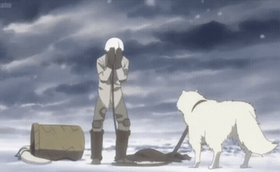 A Man Is Standing In The Snow With His Hands On His Face And A Dog Standing Next To Him . GIF