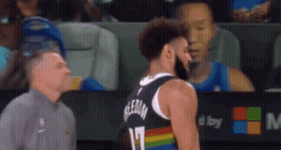 A Man Is Standing Next To A Basketball Player Who Is Wearing A Rainbow Colored Jersey . GIF