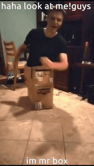 A Man Is Standing Next To A Cardboard Box That Says Im Mr Box On It GIF