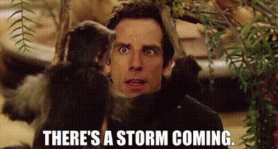 A Man Is Standing Next To A Monkey With The Words `` There 'S A Storm Coming '' Written On It . GIF