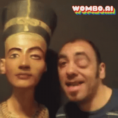A Man Is Standing Next To A Statue Of A Woman With Wombo.ai Written In The Corner GIF