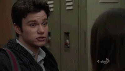 A Man Is Standing Next To A Woman In A Locker Room And Making A Funny Face . GIF