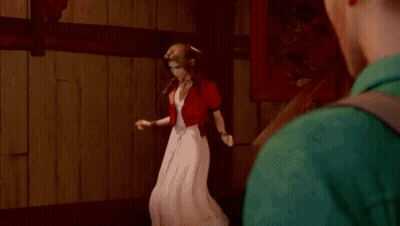 A Man Is Standing Next To A Woman In A Red Dress In Front Of A Mirror . GIF