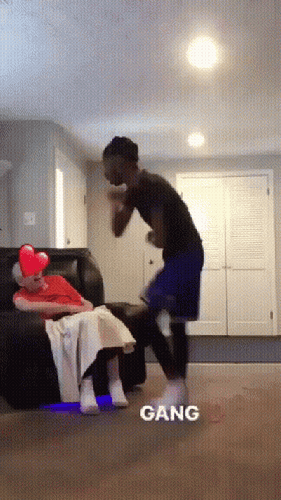 A Man Is Standing Next To A Woman Sitting On A Couch And The Word Gang Is On The Bottom GIF