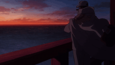 A Man Is Standing On A Balcony Overlooking The Ocean GIF