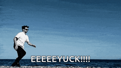 A Man Is Standing On A Beach With The Words Eeeeyuck !!! Behind Him GIF