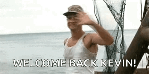A Man Is Standing On A Boat In The Ocean And Waving At The Camera . GIF