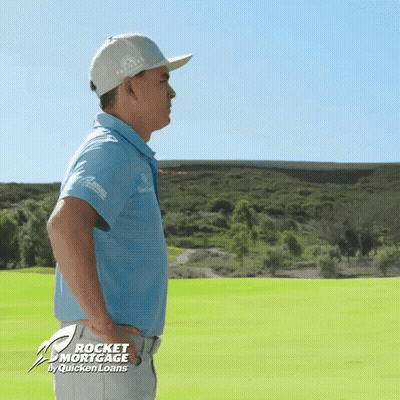 A Man Is Standing On A Golf Course With Rocket Mortgage By Quicken Loans On The Bottom GIF