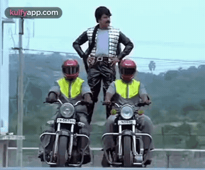 A Man Is Standing On A Motorcycle Next To Two Other Men Riding Motorcycles . GIF