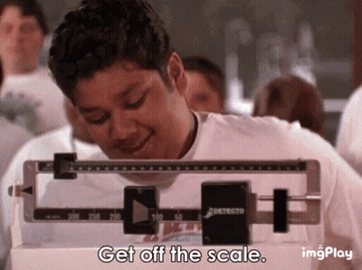 A Man Is Standing On A Scale With The Words Get Off The Scale . GIF