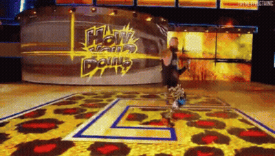 A Man Is Standing On A Stage In Front Of A Sign That Says ' How Can I Do N't ' . GIF