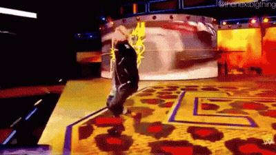 A Man Is Standing On A Stage With A Leopard Print Rug And A Yellow Background . GIF