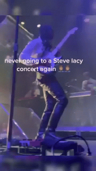 A Man Is Standing On A Stage With A Microphone And A Caption That Says Never Going To A Steve Lacy Concert Again GIF