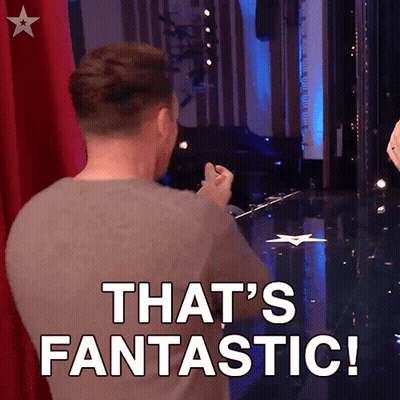 a man is standing on a stage with the words that 's fantastic behind him