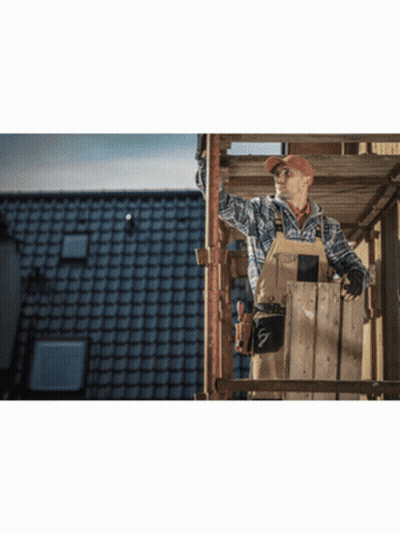 A Man Is Standing On A Wooden Scaffolding Looking Up At The Sky GIF