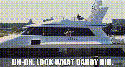 A Man Is Standing On The Deck Of A White Yacht With The Words Uh-Oh Look What Daddy Did GIF
