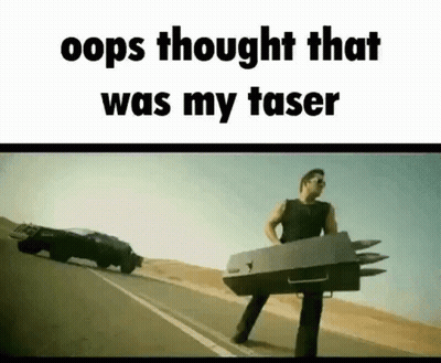 A Man Is Standing On The Side Of A Road Holding A Box With Missiles Attached To It . GIF