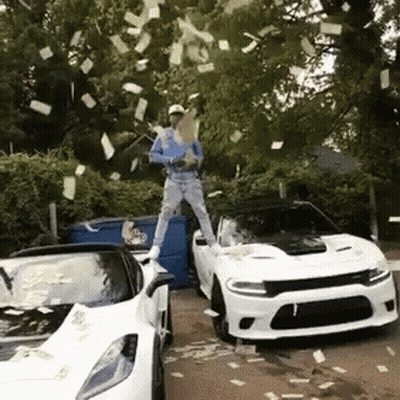 A Man Is Standing On Top Of A White Sports Car While Money Is Falling From The Trees GIF