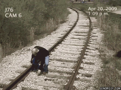 A Man Is Standing On Train Tracks With The Date April 20 2009 On The Bottom GIF