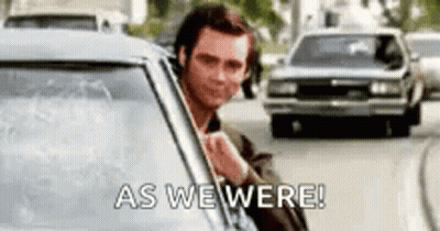 A Man Is Sticking His Head Out Of A Car Window And Saying `` As We Were '' . GIF