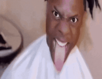 A Man Is Sticking His Tongue Out In A Funny Face . GIF
