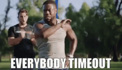 A Man Is Stretching His Arms In A Park With The Words `` Everybody Timeout '' . GIF