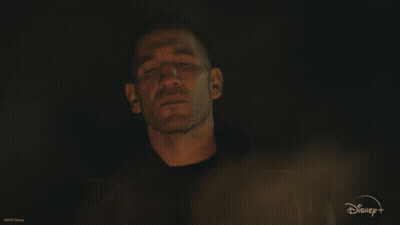 A Man Is Surrounded By Flames With A Disney Logo In The Background GIF